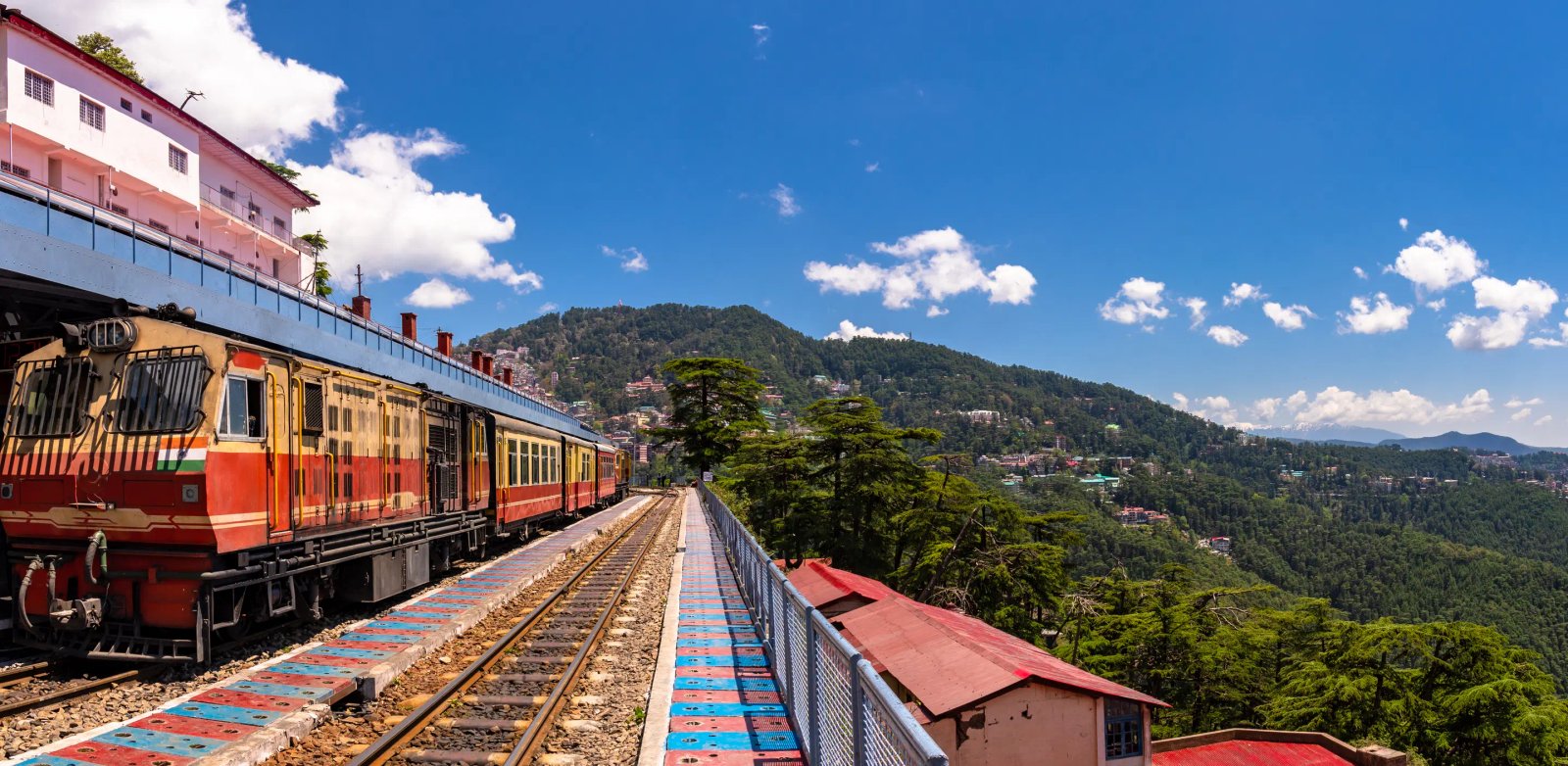 Traditional mountain wooden architecture facing towering Himalayan peaks